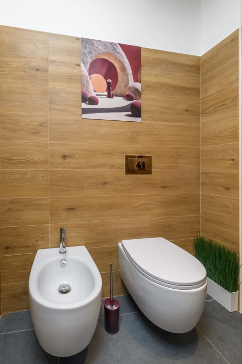 Bagno moderno ad Almatros Sulmona con rivestimenti in legno, bidet e wc in ceramica bianca