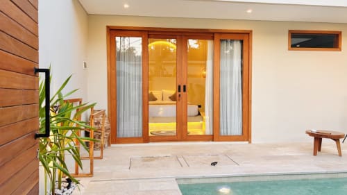 Oasis Dune Villas villa terrace with wooden sliding doors, pool, and tropical garden in Lombok Tengah