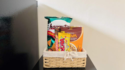 Welcome basket with snacks and granola in woven tray at Oasis Dune Villas, Lombok villa accommodation
