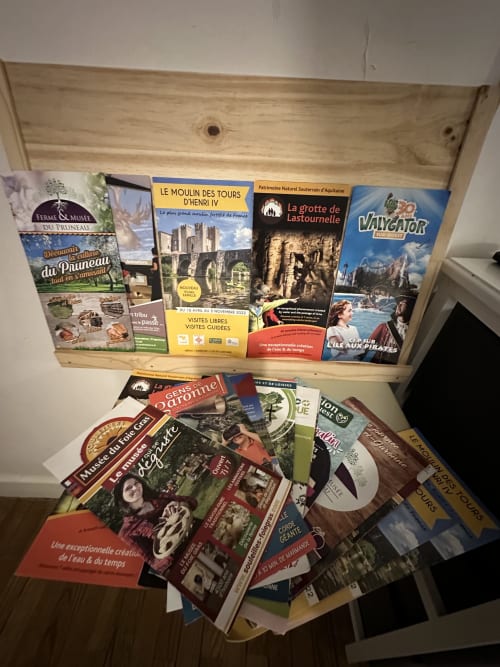 Tiroir en bois rempli de brochures touristiques et guides des attractions locales de la région de Villeneuve-sur-Lot