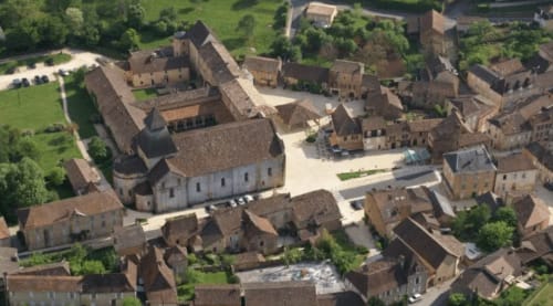 Vue aérienne des Gîtes Le Pech en Sainte-Foy-de-Longas, avec l'église médiévale et bâtiments de pierre du village