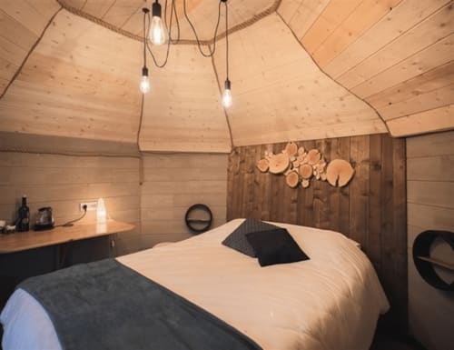 Nuit céleste bedroom at Les Murmures du Bois with wooden beams, pendant lights, and garden view