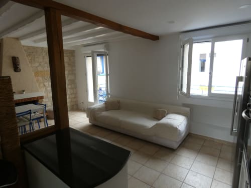 Villa lumineuse avec salon blanc, poutres en bois foncé et vue sur terrasse à Sci Ludji Nanterre