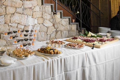 Elegante buffet all'aperto presso l'Hotel Ristorante alle Querce di Castelbuono con affettati, antipasti e bevande