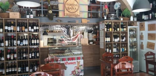 Taberna da Baixa wine bar and restaurant in Lisbon with wooden furniture, wine displays, and cream-colored countertop service