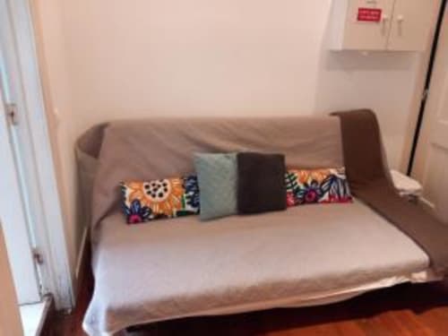 Sofa bed with colorful pillows in Lisbon apartment C165-2 at Charm Discovery Experiences