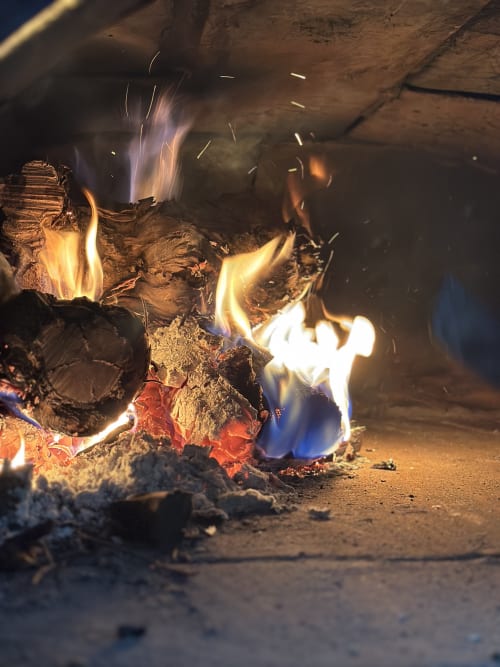 Cozy fireplace with burning wood and flames at Casa Rural Finca El Olivar cottage in Las Cuevas