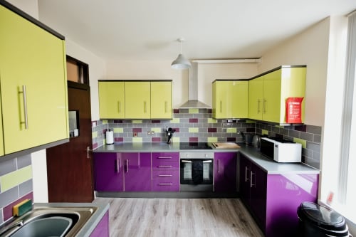 Modern lime and purple kitchen at The Residence by JS Apartments, Blackburn with stainless steel appliances