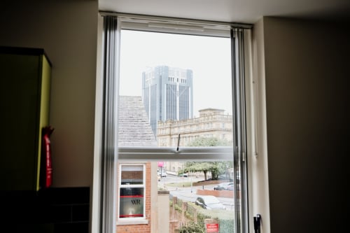 City view from The Residence apartment window in Blackburn showing modern buildings and historic architecture