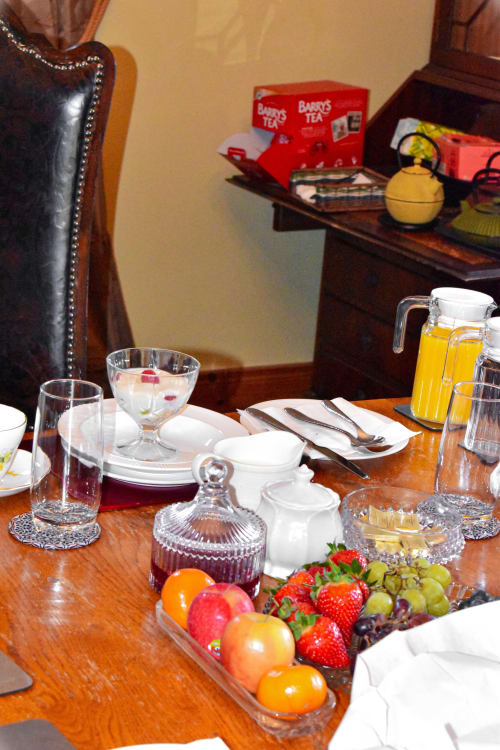 Elegant dining table at Knockaderry House B&B with fresh fruit, place settings, and glassware