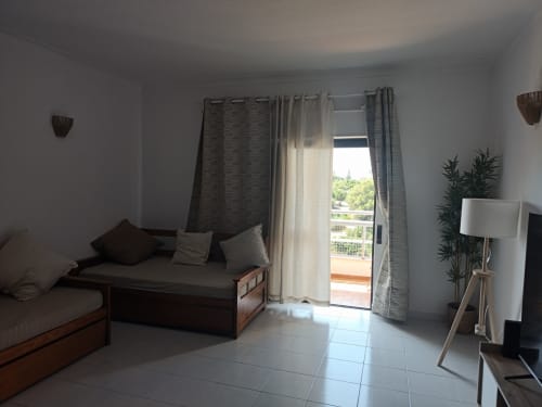 Apartamento estúdio luminoso na Albufeira Inn com área de estar, vista para a varanda, móveis modernos e decoração com plantas
