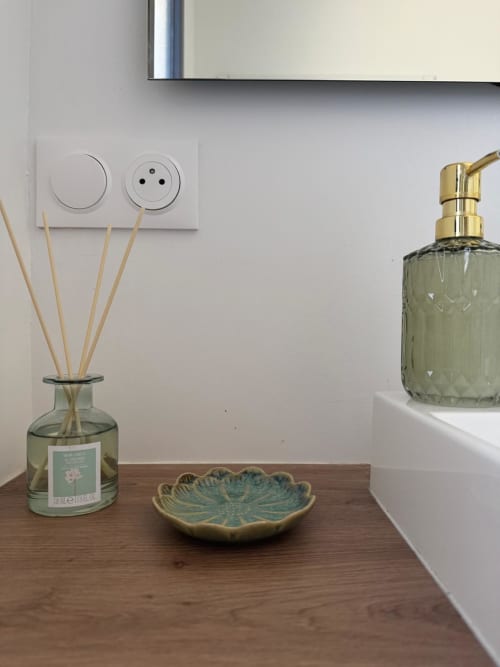 Bathroom vanity at Les clés d'à côté maison d'hôtes in Sotteville-lès-Rouen with reed diffuser, ceramic dish, and soap
