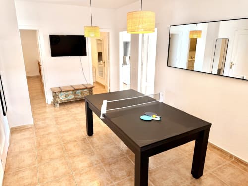 Moderna sala de recreo con mesa de ping pong, televisor y zona de descanso en Villa Sienna, Nerja