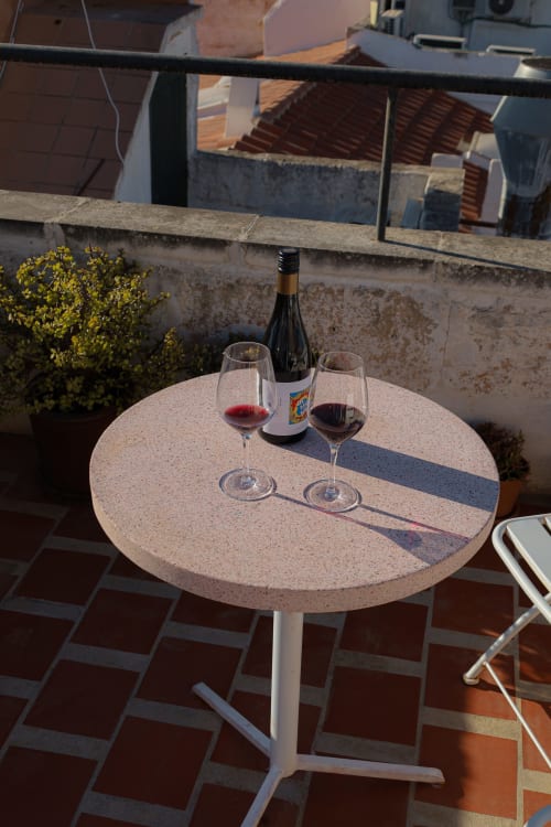 Wine and glasses on terrace table at Hotel Fragile, Ciutadella de Menorca with sea views