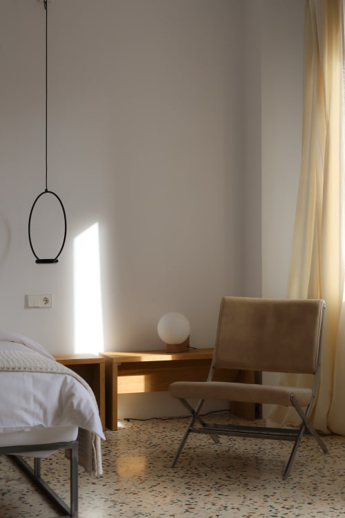Modern bedroom at Hotel Fragile in Menorca with minimalist decor, natural light, and contemporary furnishings.