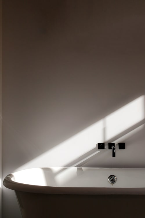 Modern bathroom sink at Hotel Fragile in Menorca with natural light and minimalist black fixtures