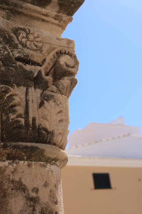 Ornate stone architectural detail at Hotel Fragile, Ciutadella de Menorca, overlooking historic fortress
