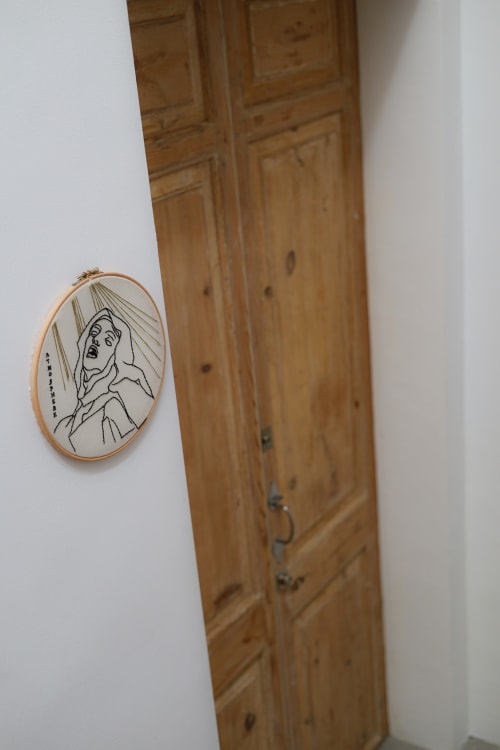 Embroidered hoop art on wooden door at Hotel Fragile, Ciutadella de Menorca