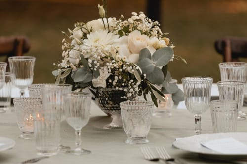 Elegante allestimento tavolo matrimoniale a Palazzo Bonfiglioli con centrotavola floreale bianco e cristalleria