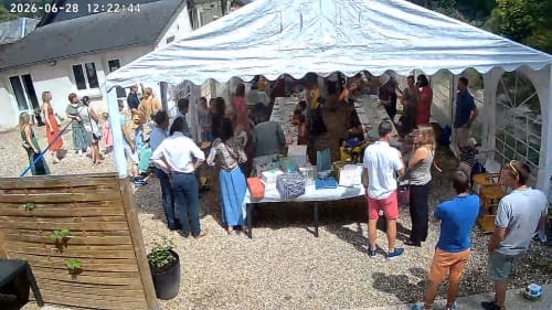 Outdoor event tent at Les Gites De Flaubert gathering many guests at tables, le heron France