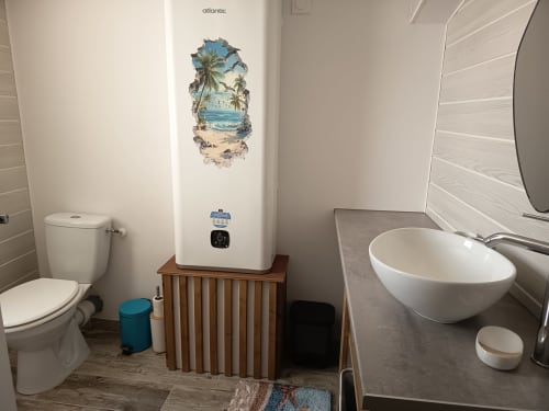 Modern bathroom at Pugetvilla cottage in Puget-Ville with white fixtures, Atlantic water heater, and coastal decor