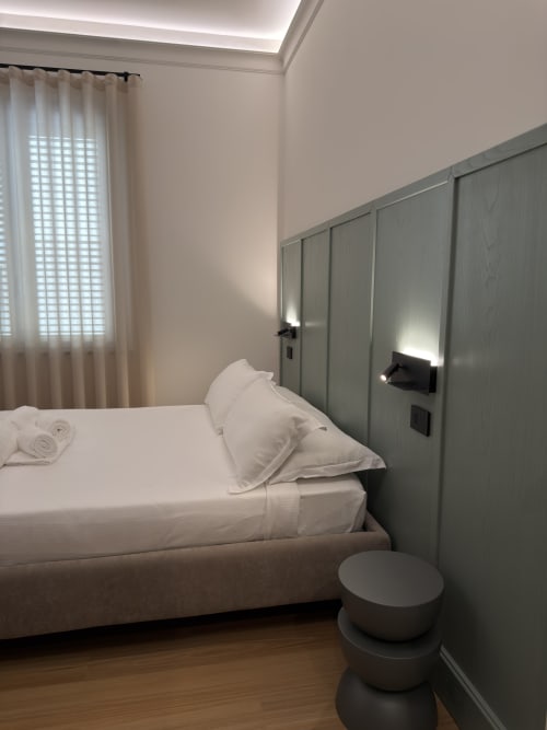 Camera moderna a Maison Riviera, Reggio di Calabria, con letto matrimoniale, testata verde e arredamento minimalista