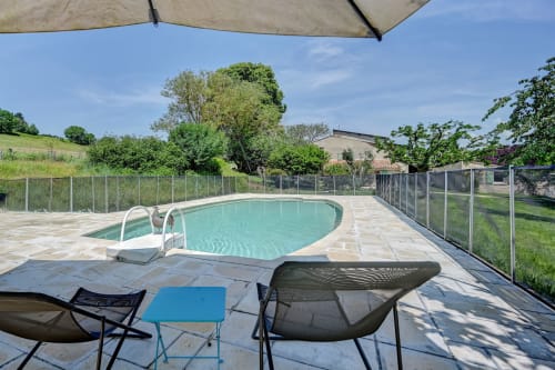Lounge au bord de la piscine du Domaine Bellavigne Gîtes et Spa à Forcalquier avec mobilier et bassin turquoise