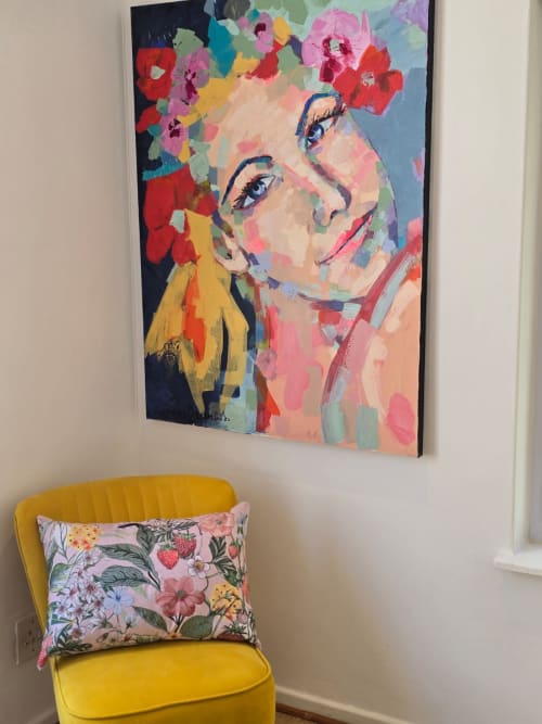 Colorful pop art portrait above yellow chair with floral pillow in Stellenbosch guesthouse Art House apartment