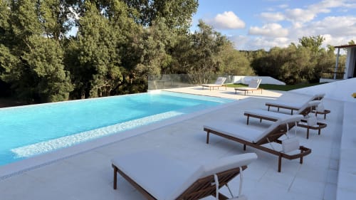 Luxury poolside at Herdade Do Vidigal in Montemor-o-Novo with sun loungers, turquoise water, and olive trees