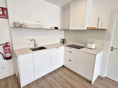 Cocina blanca moderna en apartamento BR SILGAR, Sanxenxo, con fregadero, placa de cocción y suelos de madera