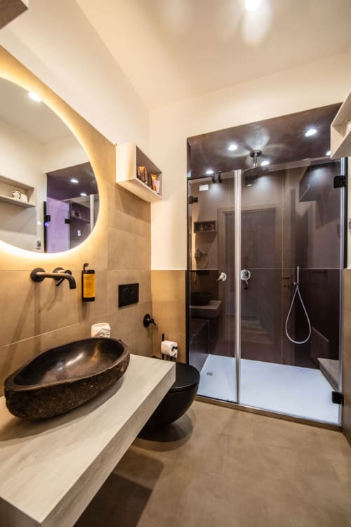 Modern bathroom in Superior Suite apartment at Suite Apartment Taormina with black oval sink, illuminated mirror, walk-in