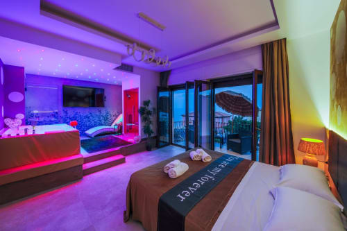 Luxury Superior Suite in Taormina with neon-lit bedroom, hot tub, sea views, and modern amenities
