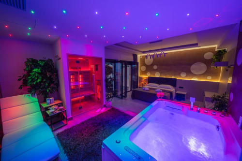 Modern Superior Suite apartment in Taormina with neon-lit bedroom, sauna, and spa-style bathroom featuring contemporary