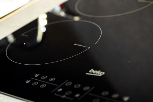 Induction cooktop in Suite Apartment Taormina kitchen with modern black surface and touch controls