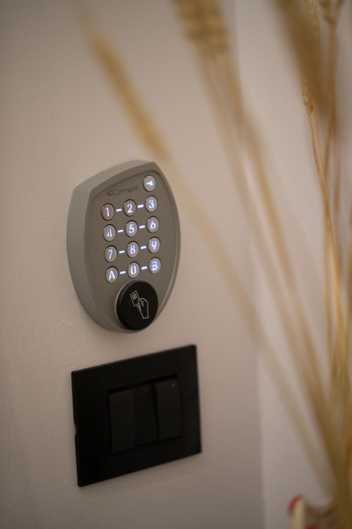 Cornelit keypad security system mounted on white wall in Taormina suite apartment room