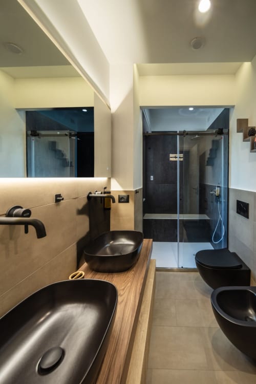 Modern bathroom with dual black vessel sinks, walk-in shower, and heated mirror at Suite Apartment Taormina, Sicily