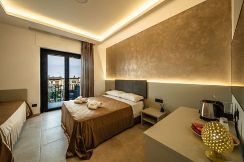 Luxurious Superior matrimonial suite at Taormina with sea view balcony, marble floors, ambient lighting, and modern amenities