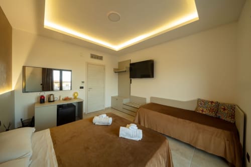 Spacious Superior matrimonial suite at Suite Apartment Taormina with twin beds, flat-screen TV, kitchenette, and modern