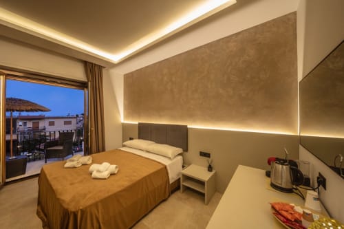 Luxury bedroom at Suite Apartment Taormina with sea view balcony, ambient lighting, and modern amenities