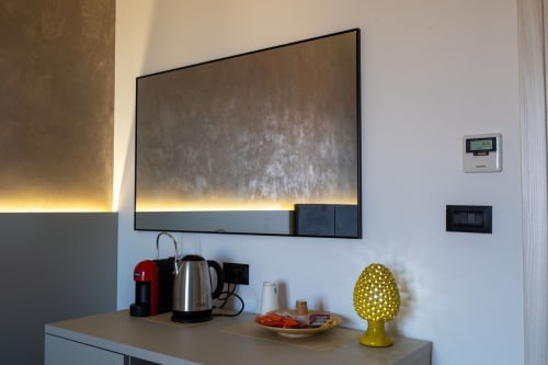 Modern kitchenette in Superior room at Suite Apartment Taormina with wall-mounted TV, coffee maker, and kettle