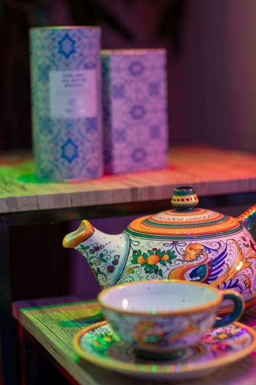 Colorful hand-painted teapot and cup with traditional patterns at Suite Apartment Taormina