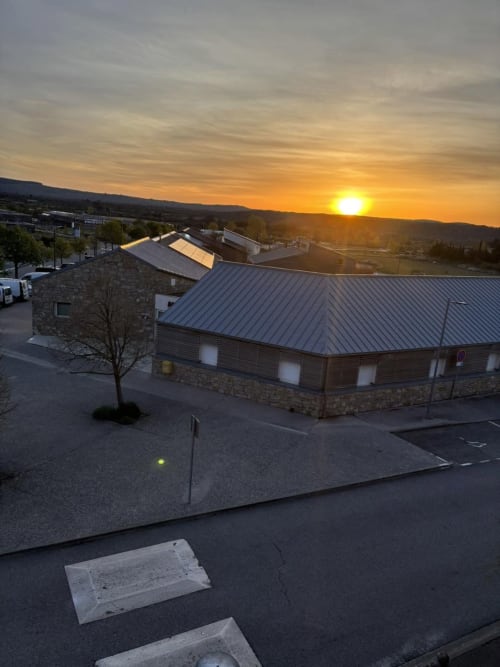 Hôtel Du Rocher in Le Caylar at sunset with modern stone building and valley views