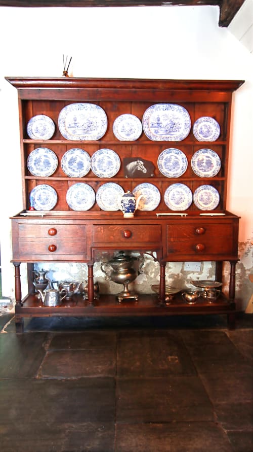Antique wooden dresser with blue and white decorative plates displayed in Llwyncadfor holiday home, Llandysul