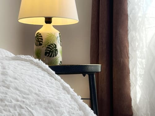 Bedside lamp with monstera leaf design on black stand at FTV Holidays Homes villa in Geafond, Spain