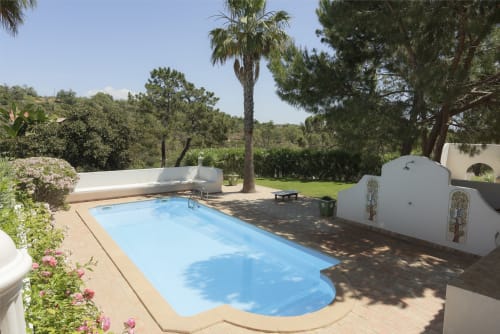 Private pool at RB Algarve villa in Boliqueime, Portugal with lush gardens and palm trees