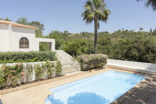 Private villa with swimming pool at RB Algarve, Boliqueime, Portugal, featuring white architecture and lush gardens