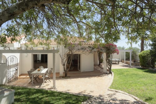 RB Algarve villa PHILL in Boliqueime featuring covered patio with dining table, white-washed architecture, mature trees, and