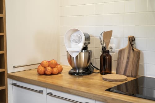 Modern kitchen counter at RB Algarve villa with mixer, cutting board, oranges, and appliances