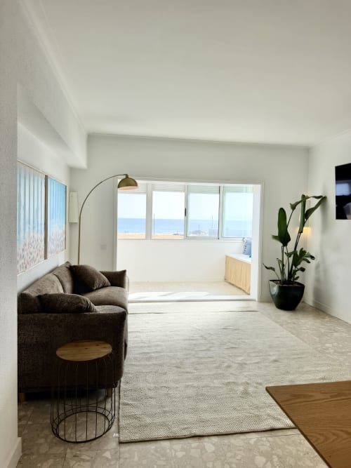Apartamento moderno com vista para o mar em República do Sul, Charneca da Caparica, sala de estar espaçosa, poltrona marrom e oceano