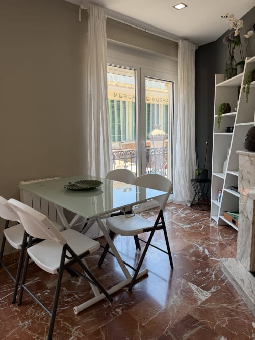 Modern dining area in The Ruzafa Market Apartment, València, with city views and contemporary furniture